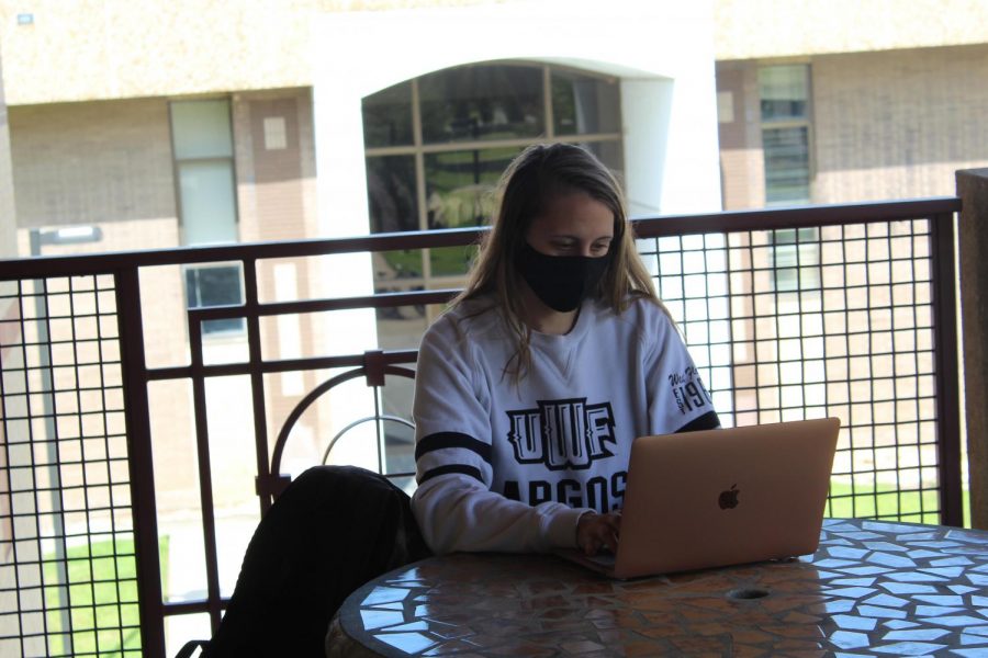  Brooklynn McCoy, UWF student double-majoring in Music Performance and Biology,  explores the various virtual events available to students as she practices social distancing on campus. 