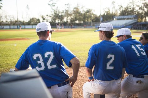 UWF baseball head coach Mike Jeffcoat (#32) and junior infielder Trent Jeffcoat (#2) watch the Argos from the dugout at Jim Spooner Field.
