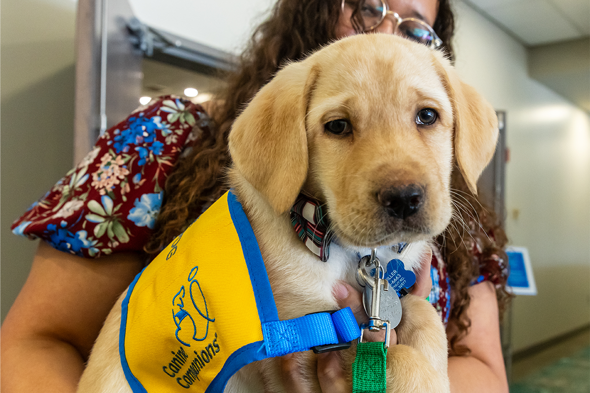 Lexi Miller holds Canine Companion puppy Veracruz