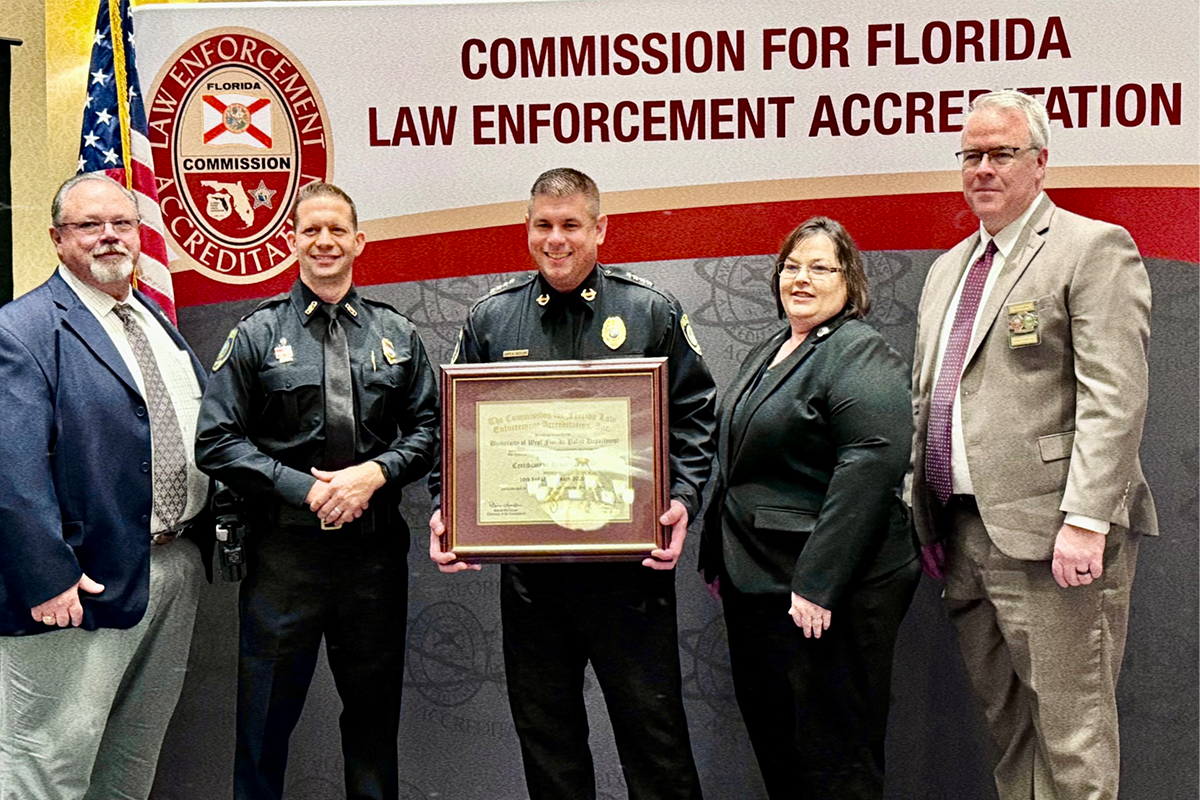 Chief Roman Jackson receives accreditation award on behalf of UWF Police Department