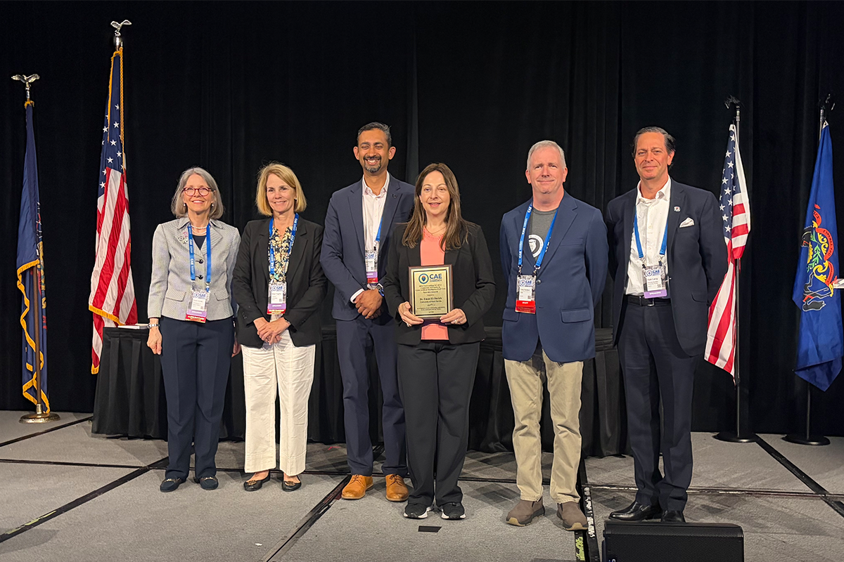 UWF's Dr. Eman El-Sheikh accepts an award for Outstanding Contributions to the CAE Cyber AI Community and Nation